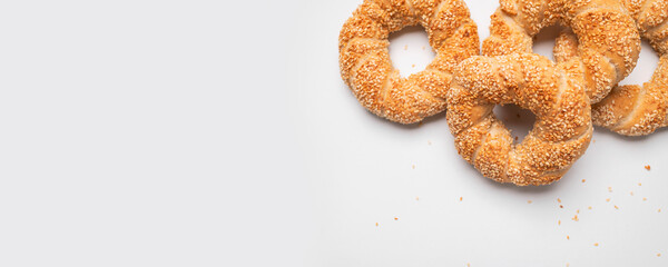Simit or gevrek, round bagel with sesame seeds on white background top view. Traditional Turkish pastry, Istanbul street food. Delicious fresh homemade pastry, bakery product. Bagel mockup