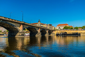 A view from the Vltava river passing under the Palacke bridge in Prague in springtime