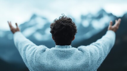 A man stands with arms wide open, embracing nature's beauty and freedom amidst a breathtaking mountain landscape, symbolizing liberation, adventure, and connection to nature.