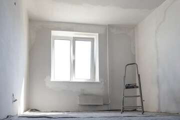 Plastered walls. An empty room during renovation. The interior concept of a house without decoration.