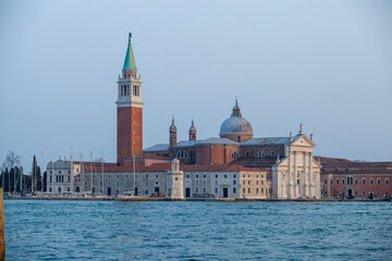 Fototapeta premium Panoramic view of San Giorgio Maggiore Basilica and its iconic bell tower rising majestically from the tranquil Venetian lagoon, showcasing the classical Renaissance architecture and historical grande