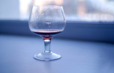glass of wine blurred background of the window
