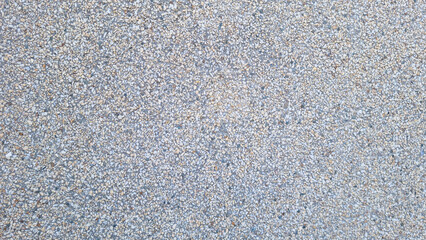 Gravel stone surface with small crushed rocks in beige and gray tones. Seamless texture background....