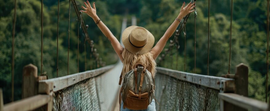 The woman enjoying freedom on a scenic forest bridge.