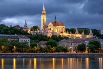 Naklejka premium Illuminated Matthias Church in Budapest against a stormy sky reflected in the Danube River