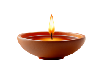 Handmade clay oil lamp with a small flame glowing softly