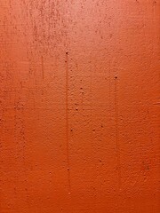 Dark orange wall covered with plaster texture 