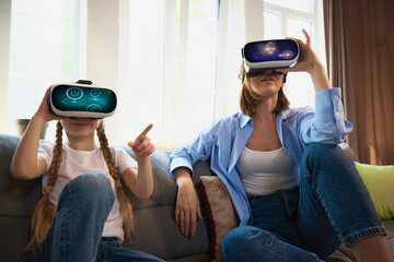 A mother and daughter enjoy a virtual reality experience in a cozy living room. Concept of family bonding through technology and shared digital experiences.