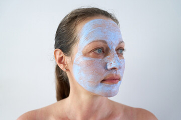Portrait of woman with healing mask on her face.