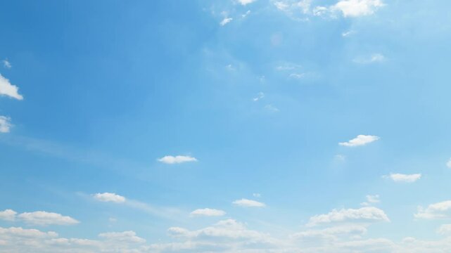 A beautiful blue sky with soft, white clouds, captured in a timelapse for an abstract background