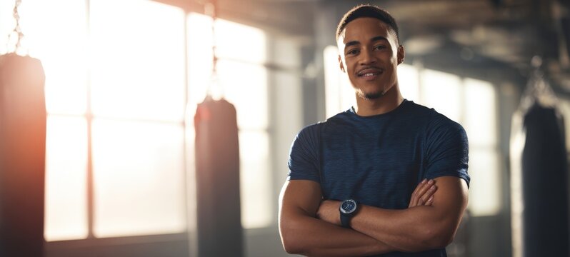 The confident athlete standing proudly in a training gym environment. - Powered by Adobe