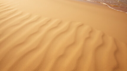 Soft sand patterns create serene landscape by water edge, evoking sense of calm and tranquility