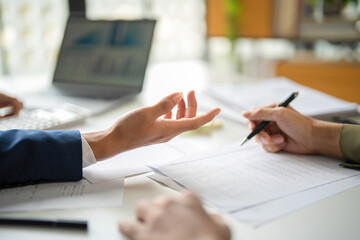 Businessmen working together at desk.