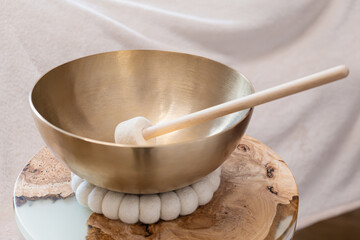 Singing Bowl with Mallet on Wooden Surface