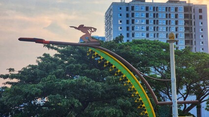 The image shows the Dirgantara Monument, also known as Tugu Pancoran or the Pancoran Statue,...