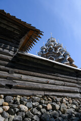 Fence made of logs and stones around the medieval wooden Church of the Transfiguration of the Lord built in 1714 on Kizhi Island on Onega Lake in Karelia