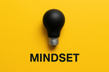 A centered black light bulb on a vibrant yellow background symbolizes innovation and the spark new business ideas