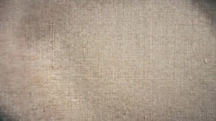 Macro video of textured linen fabric gently fluttering as wind passes - Powered by Adobe