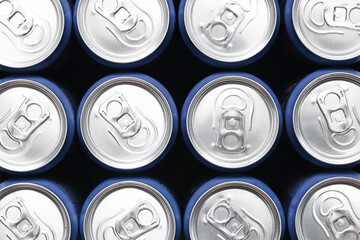 Aluminum soda cans top view. Cold drinks packed in silver. Repeating round shapes with tabs....