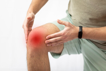 The man grabbed his knee due to severe pain	