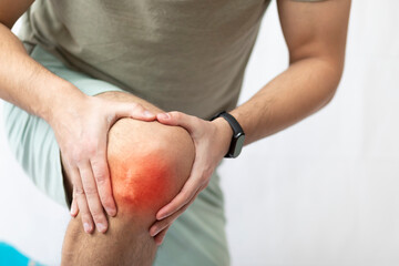 The man grabbed his knee due to severe pain	