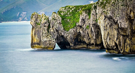 Scenic view of the cliffs and turquoise water of Playa de Cobijeru beach in Asturias, Spain
