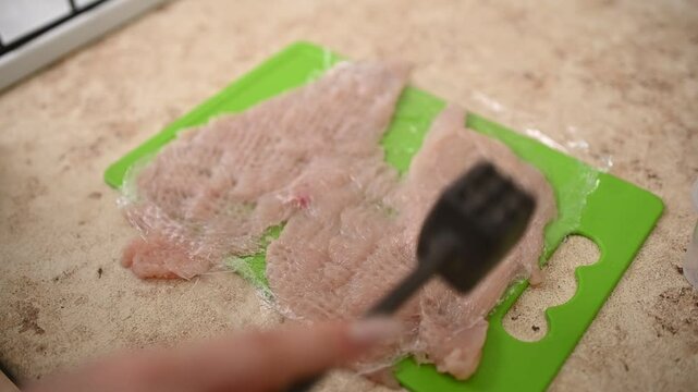 Cooking Breast Chicken Meat, Beat Chicken using Meat Tenderizer. Cooking Process in The Kitchen.