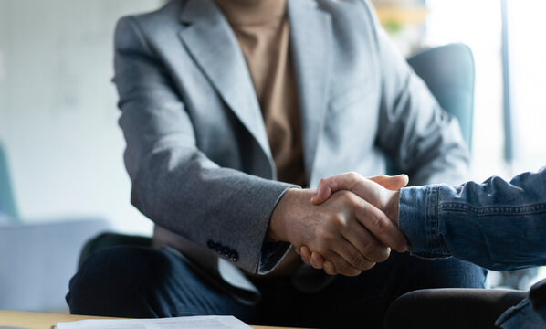 Partnership, teamwork and shaking hands for agreement, consulting or introduction in meeting