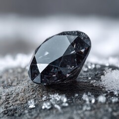 Black diamond resting on textured stone surrounded by snowflakes in a winter landscape