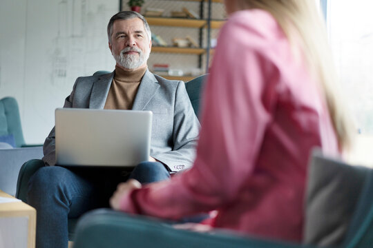 Happy mature businessman professional bank manager or financial advisor consulting woman client