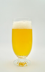 A closeup of an extra IPA beer isolated against a white background. 