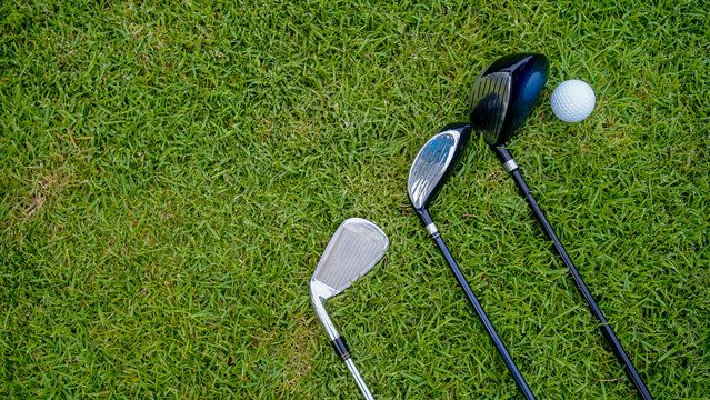 Top view of a golf ball and golf club on green in the evening golf course. - Powered by Adobe