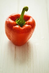 Fresh red pepper on wooden table