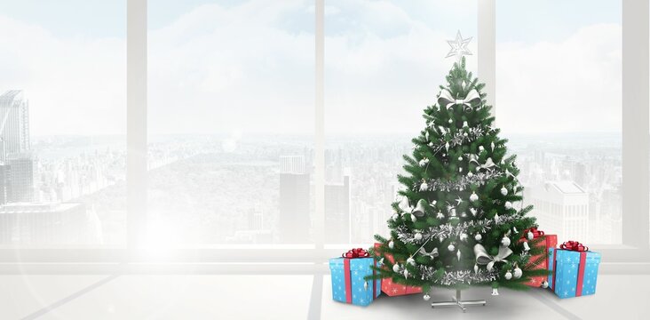Fototapeta Christmas tree is standing beside high-rise windows with silver tinsel, star topper and presents