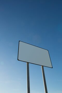 Fototapeta Blank billboard against clear blue sky