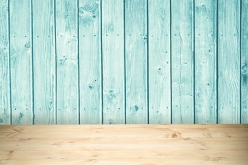 Light natural wood tabletop is sitting below soft turquoise plank wall in flat design illustration