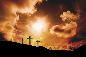 Cross religion symbol shape over sunset sky