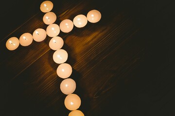 Candles in shape of cross on table