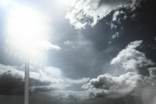 Naklejki Cloud-filled sky is showcasing sun rays, lens flare and faint pole sign in flat vector illustration