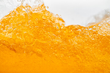 Close up bright orange Oil or beer splash texture and nature waves, Beautiful waves curve and...