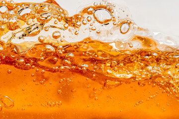 Close up bright orange Oil or beer splash texture and nature waves, Beautiful waves curve and...