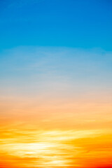 Sky,Beautiful sunset view, luxury soft gradient orange gold clouds and sunlight on the blue dramatic sky perfect for the background, morning, evening,Twilight, climate change,Vertical sunset photo