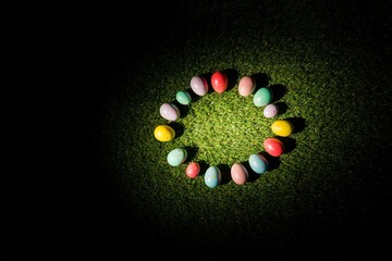 Colorful Easter eggs in circle on grass
