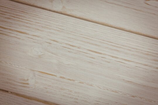 Fototapeta Light wood plank surface is being shown in flat design, with visible grain and knots