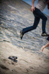 A vibrant moment was captured on the sunlit beach with people joyfully jumping and having fun...