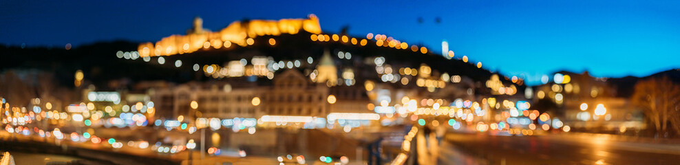 Night Boke Bokeh Blurred Ancient Fortress Narikala In Old Town Of Tbilisi. Caucasus. Tbilisi, Georgia Scenic Panoramic View Of Impregnable Fortress Narikala Fortress. Abstract Blurred Bokeh