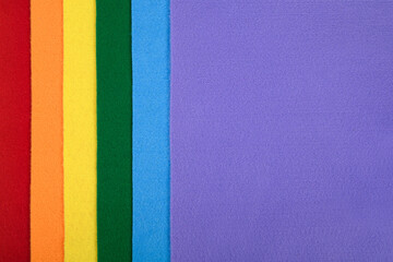 Fototapeta premium Felt samples in rainbow colors in a vertical arrangement. There is space for text. 