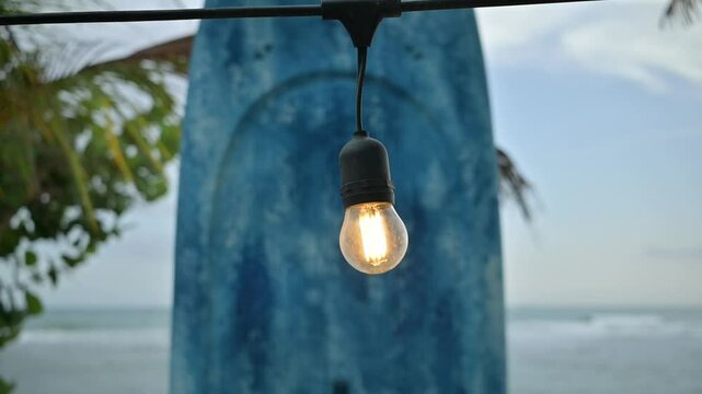 Big surfboard decorative on a Turquoise beach waves gently washing over a white sand beach in the Caribbean. Perfect for travel, tourism, wellness, and relaxation themes. Shot in slow motion for a cin