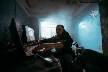 Fototapeta premium Editing director behind monitors on the set. A video editor edits video online while filming for a playback. Shooting shift, equipment and group. Modern photography technique.