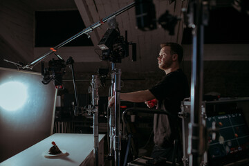 Director of photography with a camera in his hands on the set. Professional videographer at work on...